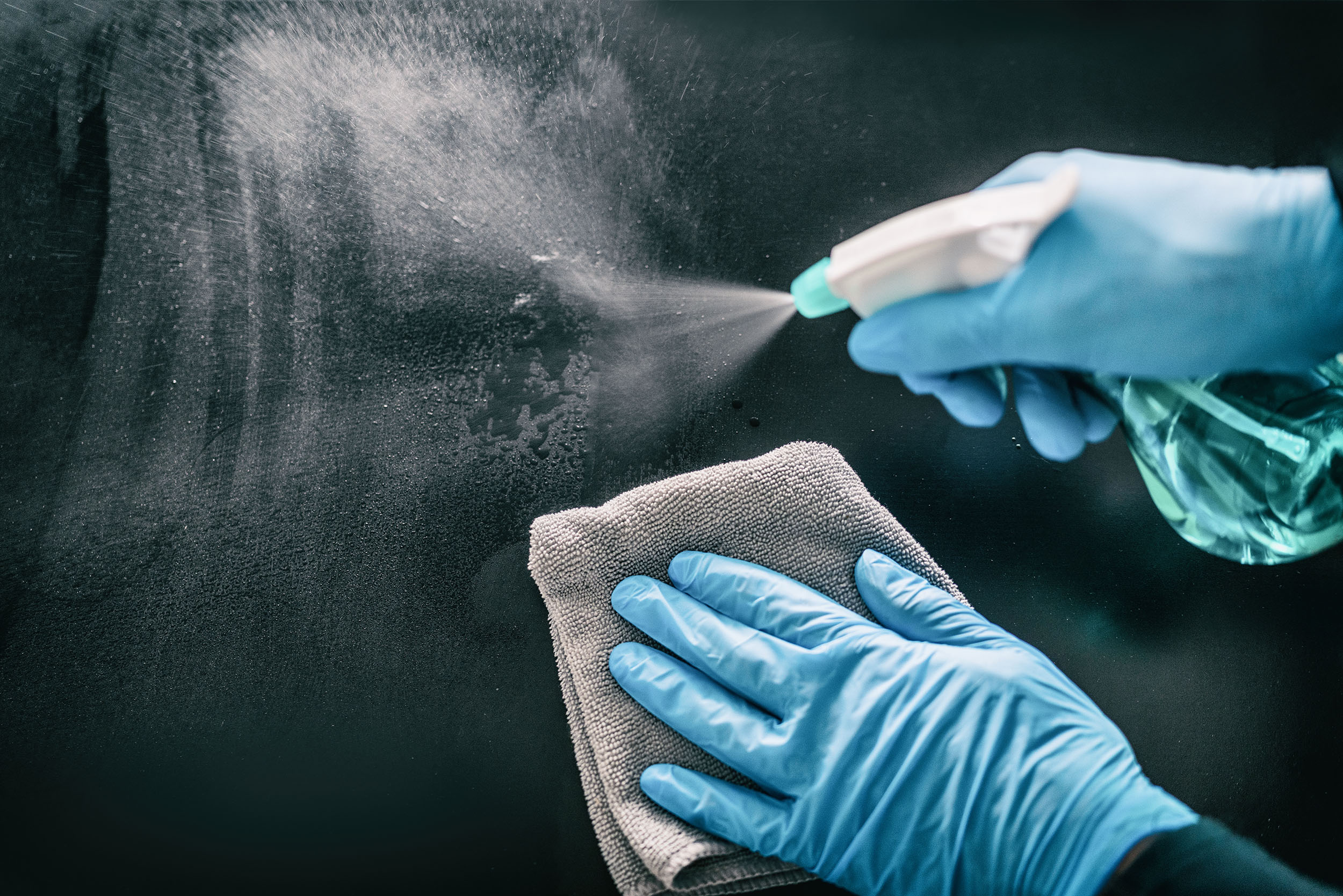 Image of someone cleaning and disinfecting a surface